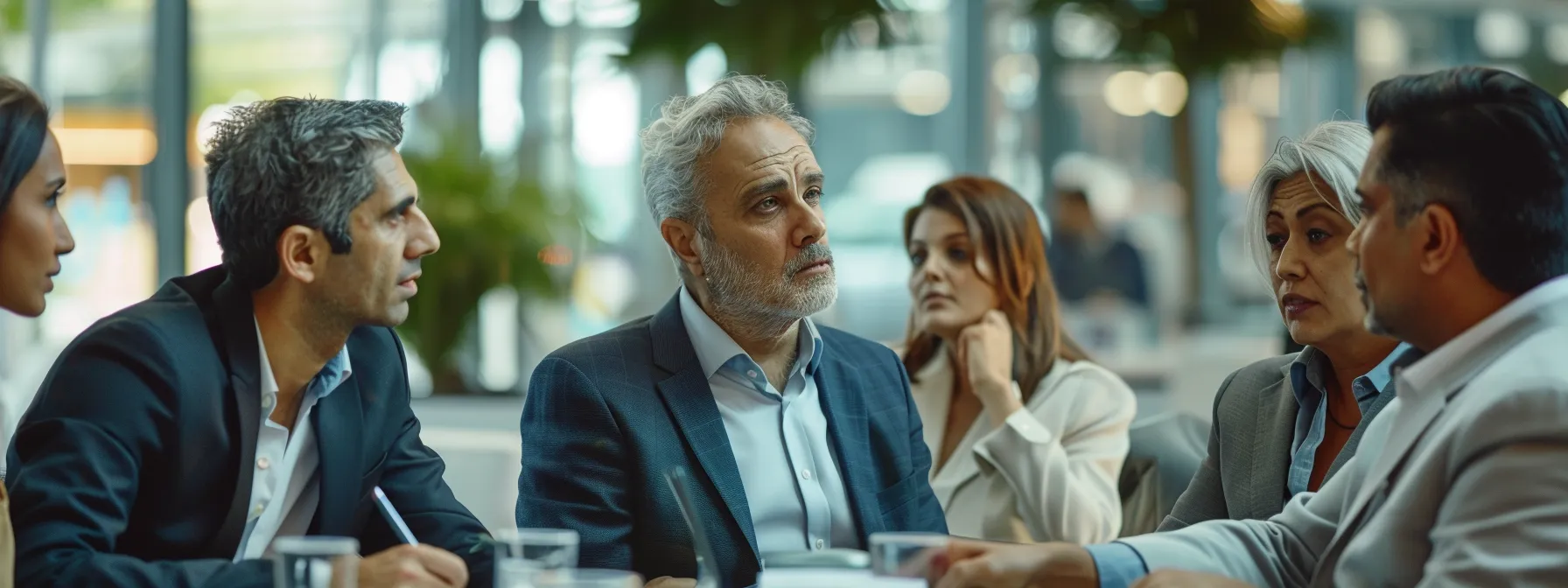 a group of business professionals discussing the benefits of ai medical scribes.