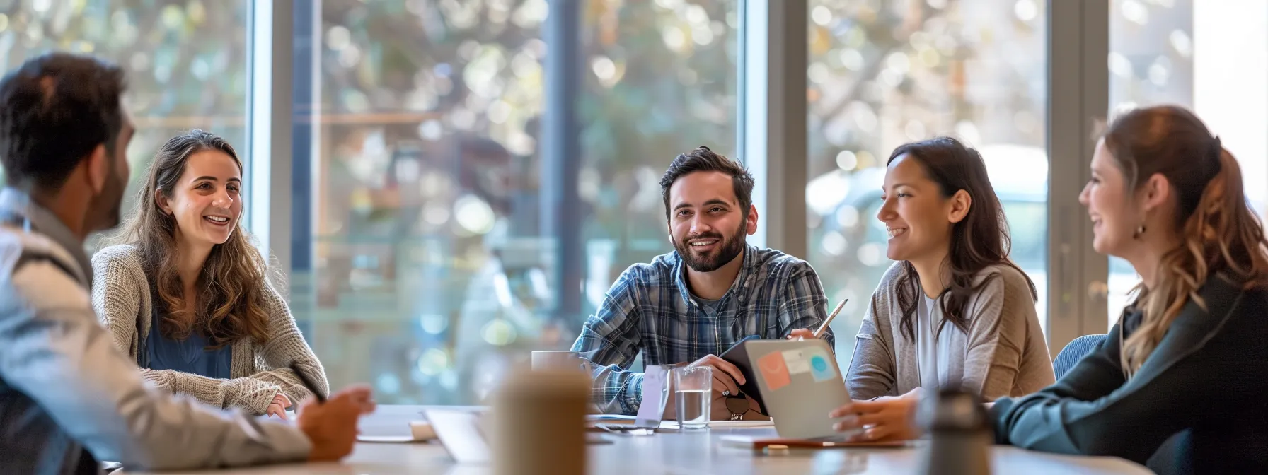 a group of professionals discussing scholarship opportunities while anchored to a table.